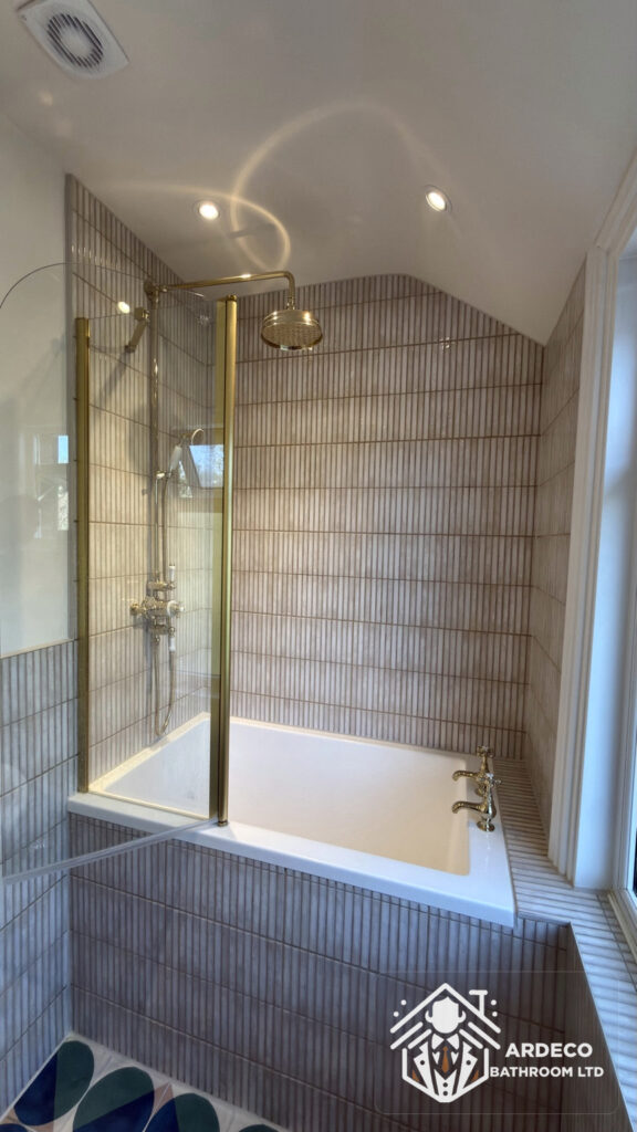 Ardeco bathroom and WC conversion – finished bath and shower screen Installed bath and glass shower screen with brass fittings in the renovated Northfields bathroom
